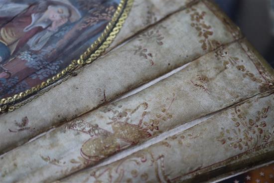 An 18th century French painted silk fan, tortoiseshell and pique work sticks